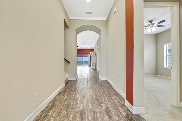 hallway featuring crown molding and hardwood / wood-style flooring