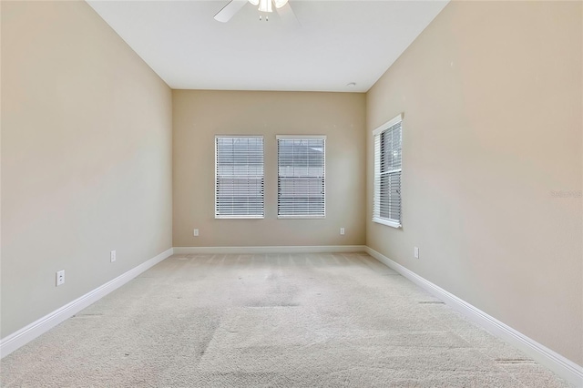 carpeted spare room featuring ceiling fan