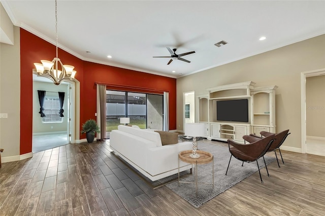 living room featuring hardwood / wood-style floors, ceiling fan with notable chandelier, and crown molding