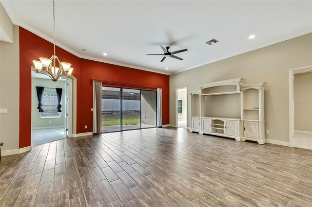 unfurnished living room featuring crown molding, wood-type flooring, and ceiling fan with notable chandelier