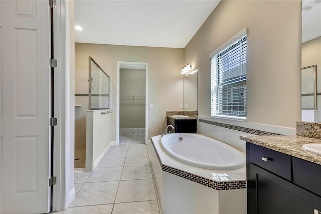 bathroom with vanity and shower with separate bathtub