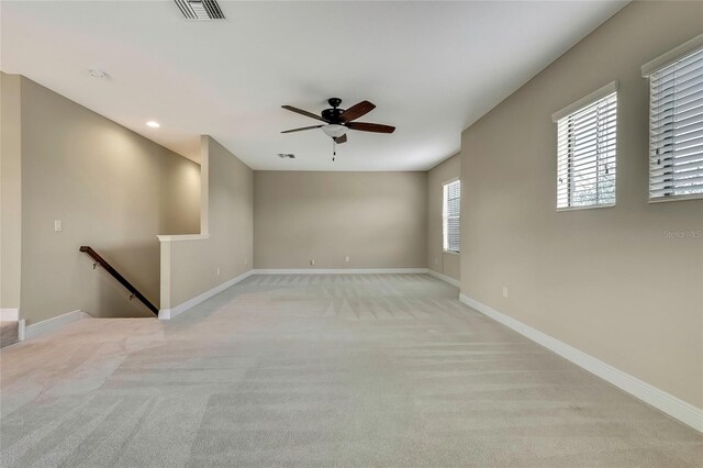 carpeted empty room featuring ceiling fan