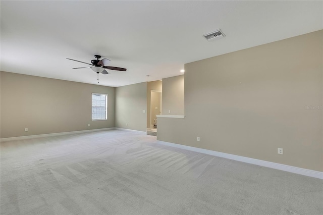 carpeted spare room featuring ceiling fan