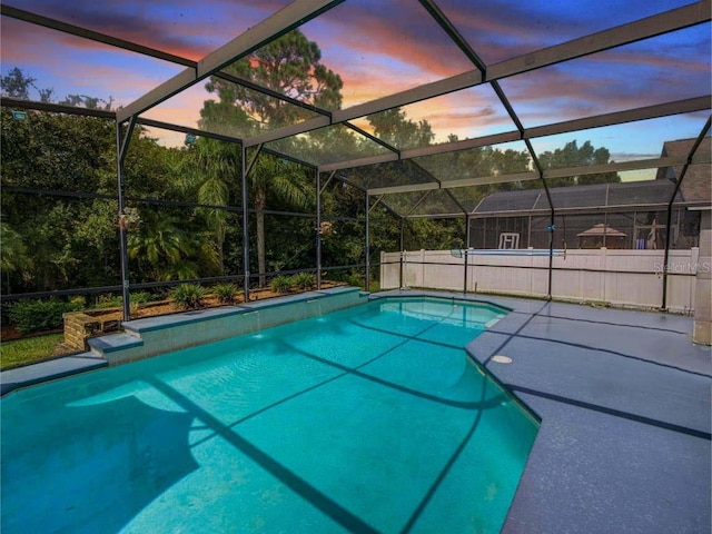 pool at dusk with glass enclosure