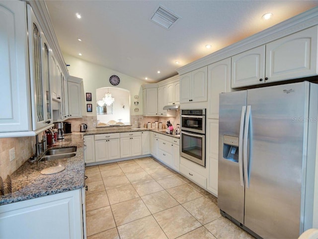 kitchen featuring white cabinets, tasteful backsplash, pendant lighting, stainless steel appliances, and sink