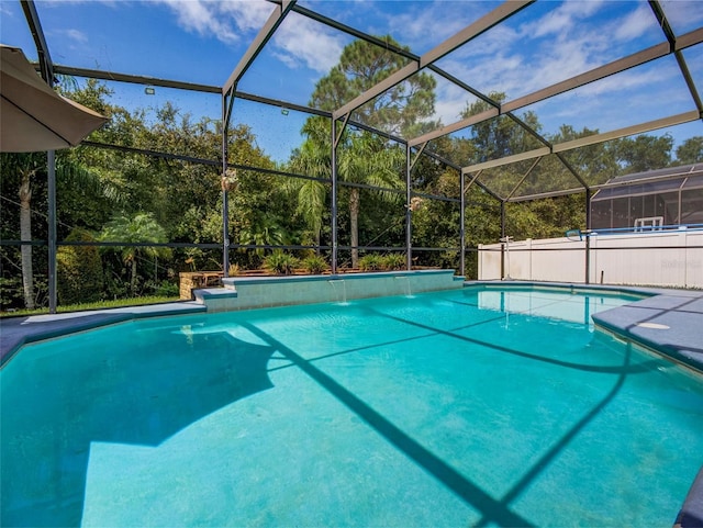 view of pool with pool water feature and glass enclosure