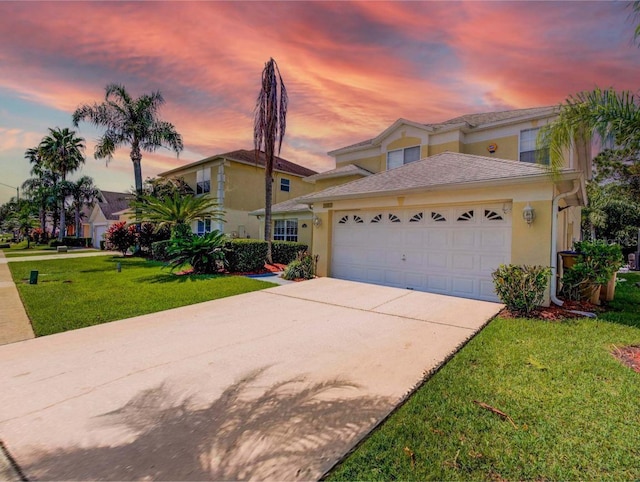 view of front of property with a lawn and a garage