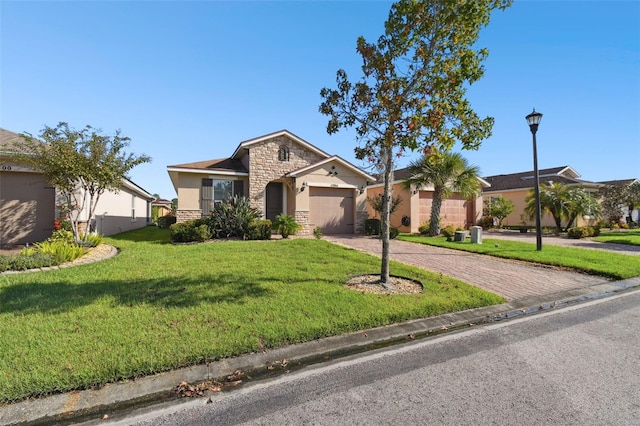 ranch-style house featuring a garage and a front lawn