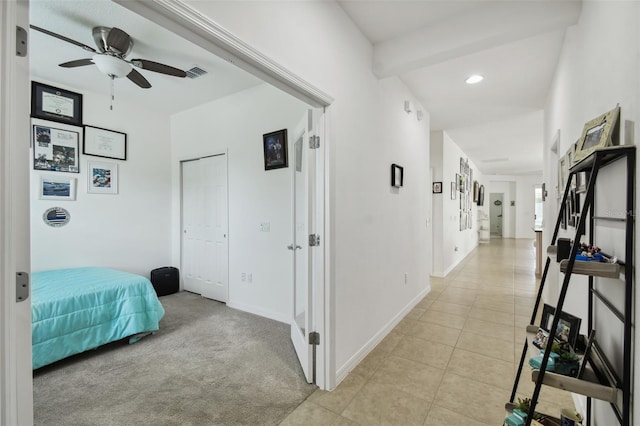 carpeted bedroom featuring ceiling fan and a closet