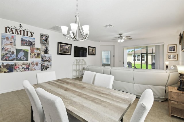 tiled dining room featuring ceiling fan with notable chandelier