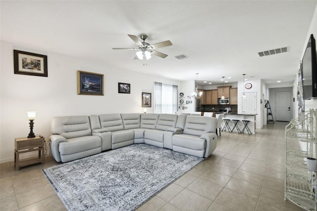 living room featuring light tile patterned flooring and ceiling fan