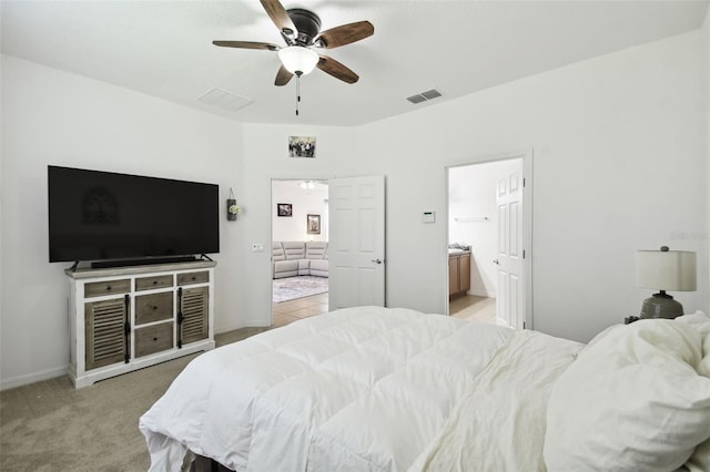 carpeted bedroom featuring ceiling fan and ensuite bathroom