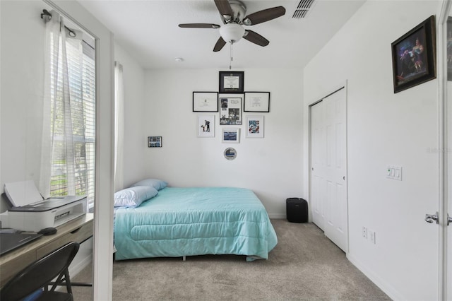 carpeted bedroom featuring ceiling fan and a closet