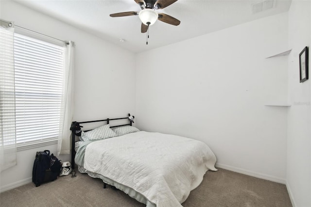 bedroom with ceiling fan and light colored carpet