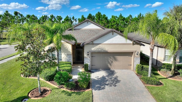 view of front of property with a front yard and a garage