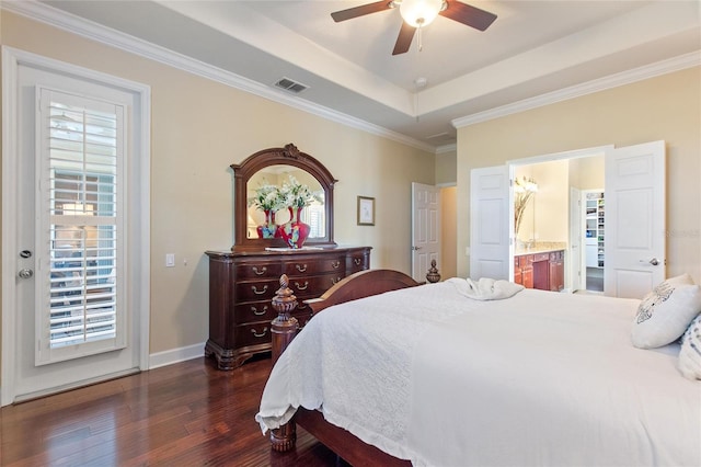 341 Navarra Ln, Davenport, FL 33837 - bedroom featuring dark wood-style flooring, baseboards, crown molding, visible vents, and a raised ceiling