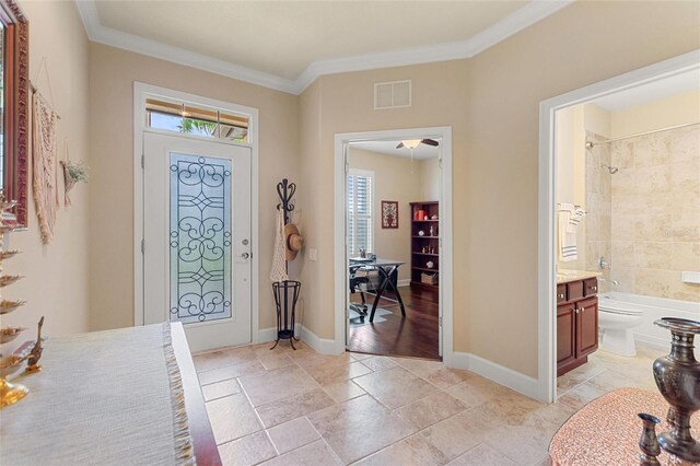 341 Navarra Ln, Davenport, FL 33837 - entrance foyer with ornamental molding, visible vents, and a healthy amount of sunlight