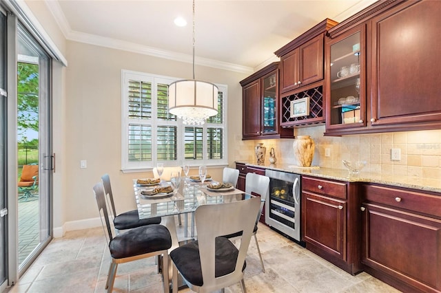 341 Navarra Ln, Davenport, FL 33837 - kitchen featuring tasteful backsplash, crown molding, beverage cooler, and light stone countertops