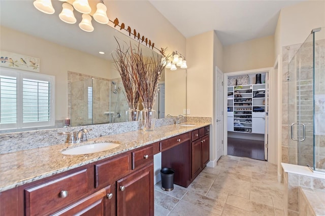 bathroom featuring a notable chandelier, vanity, and an enclosed shower