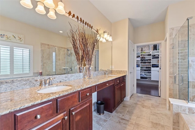 341 Navarra Ln, Davenport, FL 33837 - full bathroom featuring a shower stall, double vanity, a sink, and a walk in closet