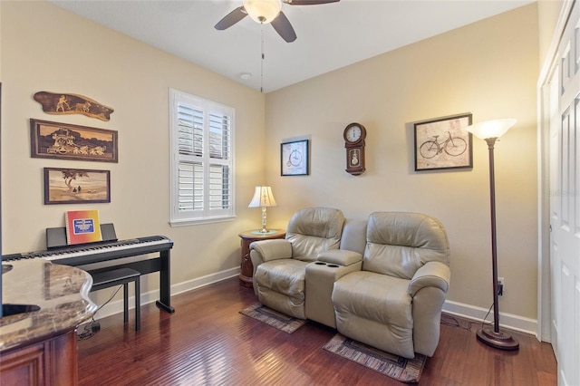 living area with dark hardwood / wood-style floors and ceiling fan