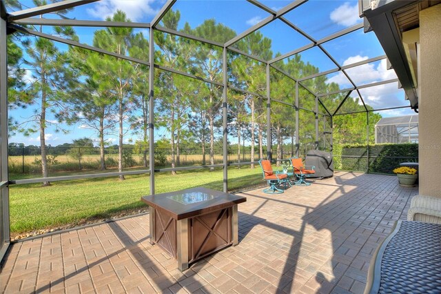 341 Navarra Ln, Davenport, FL 33837 - view of patio / terrace featuring an outdoor fire pit, grilling area, fence, and glass enclosure