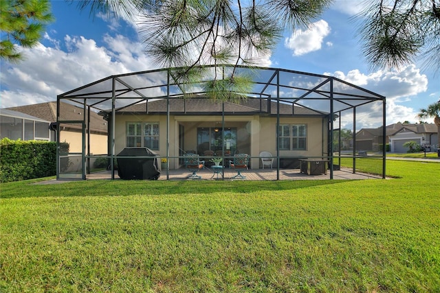 back of house featuring a yard, a lanai, and a patio area