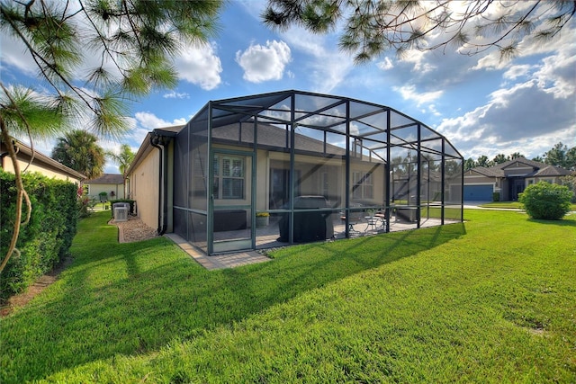 back of property featuring central AC unit, a patio, a lawn, and a lanai