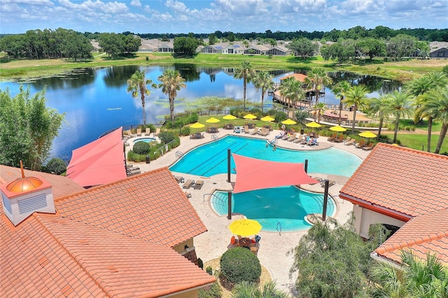 view of swimming pool featuring a water view and a patio area