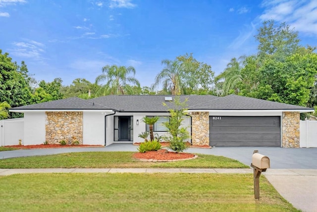 ranch-style home with a front yard and a garage