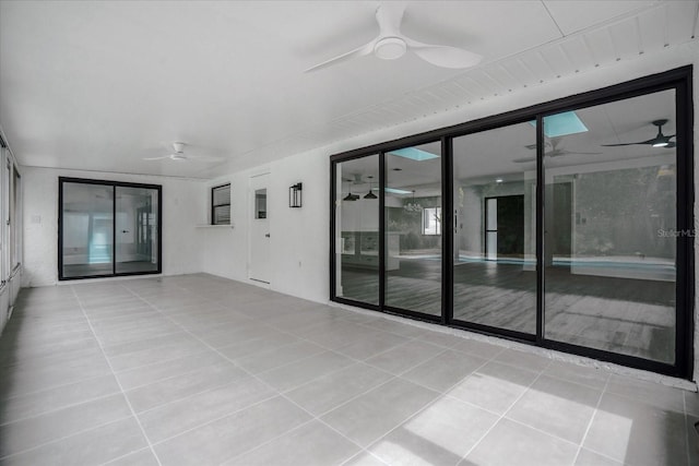 interior space with ceiling fan