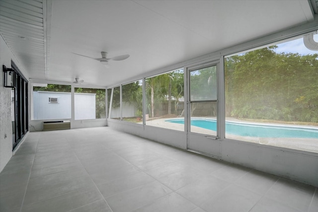 unfurnished sunroom featuring ceiling fan