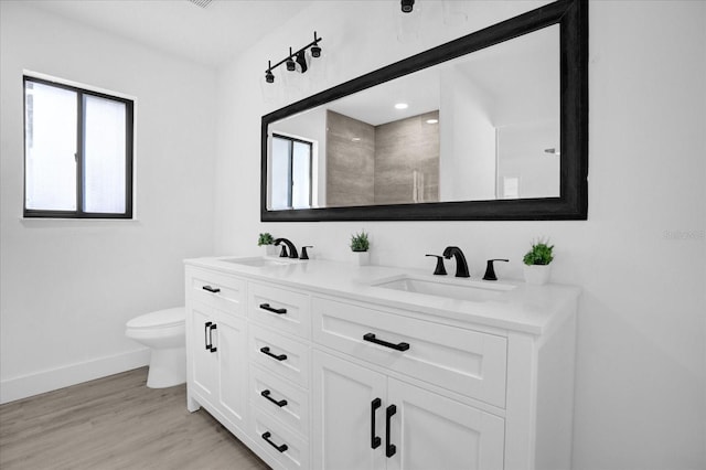 bathroom with vanity, a shower, toilet, and hardwood / wood-style flooring