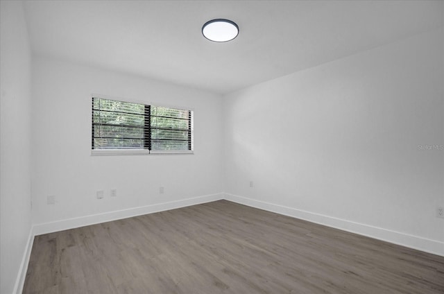 spare room with dark hardwood / wood-style floors