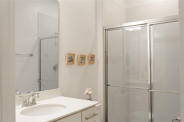 bathroom with vanity and a shower with shower door