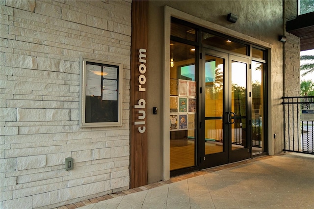 view of exterior entry featuring french doors