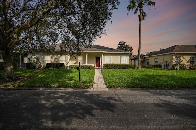 ranch-style house featuring a lawn