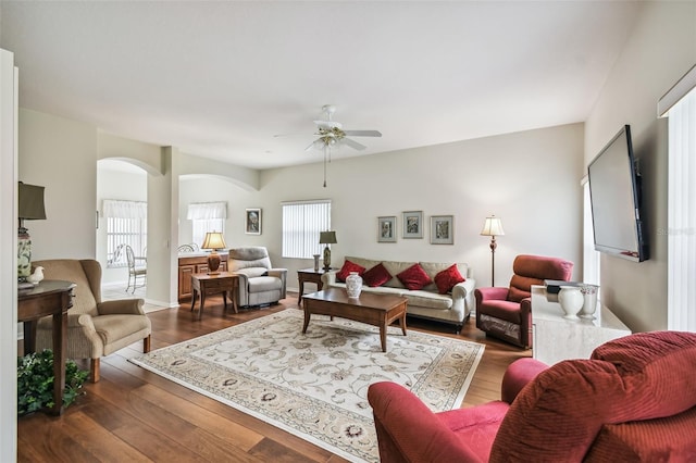 living room featuring ceiling fan and dark hardwood / wood-style flooring