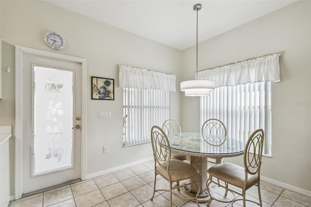 dining space featuring light tile patterned flooring