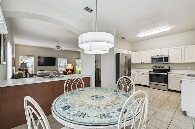 dining room with light tile patterned flooring and ceiling fan