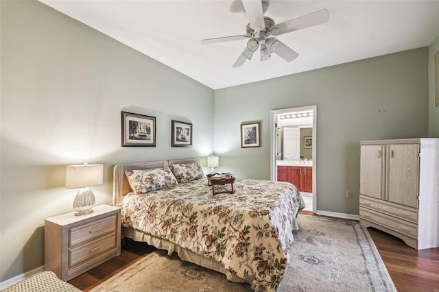 bedroom featuring ensuite bath, dark hardwood / wood-style floors, and ceiling fan