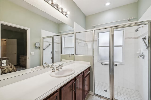 bathroom featuring vanity, tile patterned floors, and a shower with door