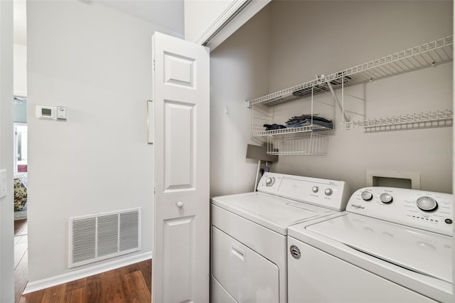 washroom featuring dark wood-type flooring and separate washer and dryer