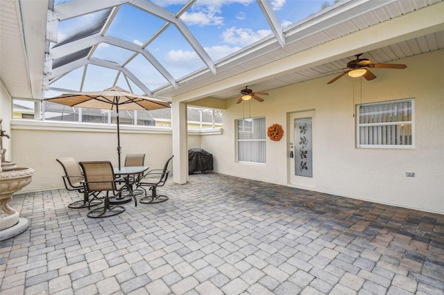 view of patio featuring area for grilling, ceiling fan, and a lanai