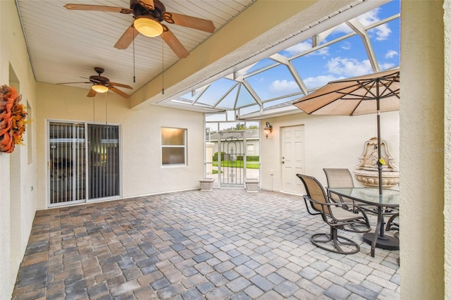 sunroom / solarium featuring ceiling fan