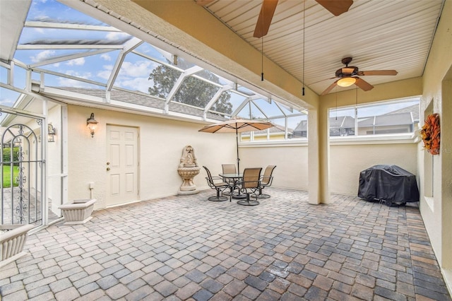 sunroom / solarium with ceiling fan and vaulted ceiling