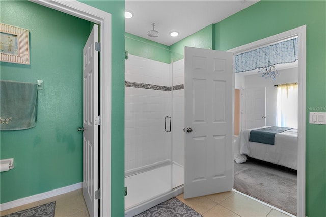 bathroom featuring a shower with shower door and tile patterned floors