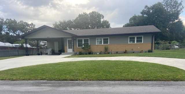 ranch-style home featuring a carport and a front yard