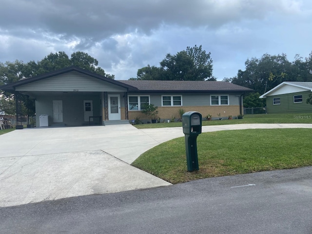 ranch-style home with a front yard and a carport