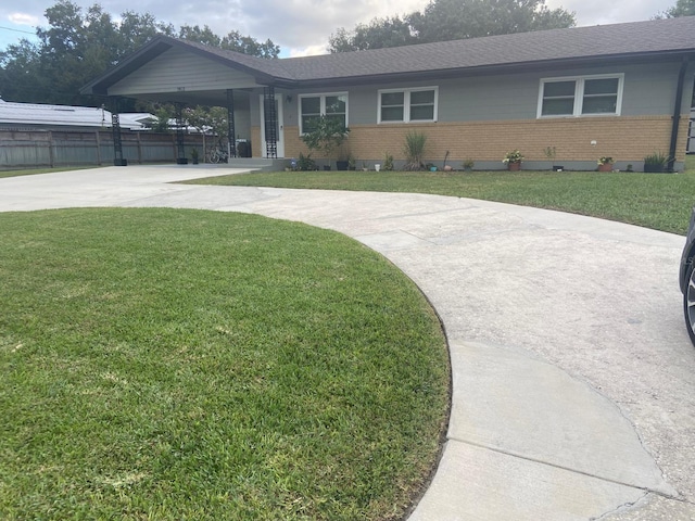 single story home with a front yard and a carport